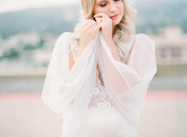 Bride with cape wrapped around her