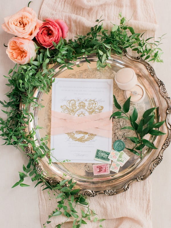 Foliage around peach wedding stationery