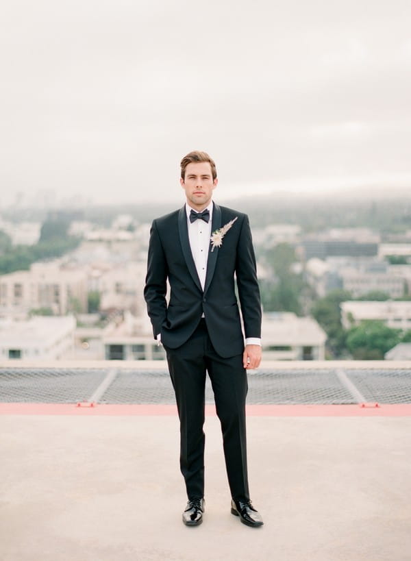 Groom in black suit and bow tie