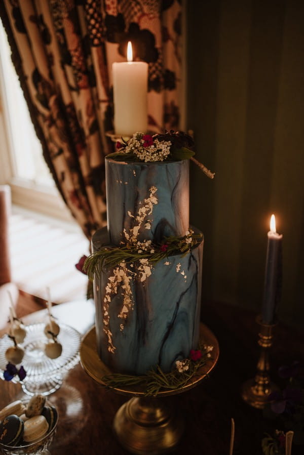 Dark blue wedding cake with gold leaf detail