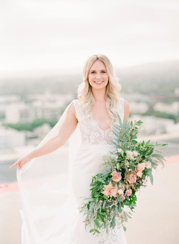 Bride holding out dress