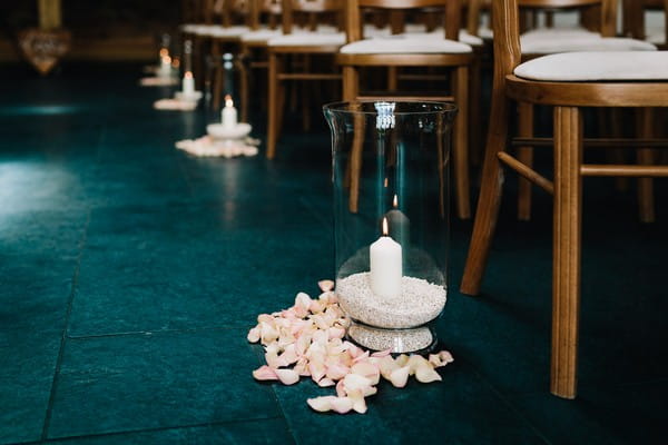Candle in vase as wedding aisle decor