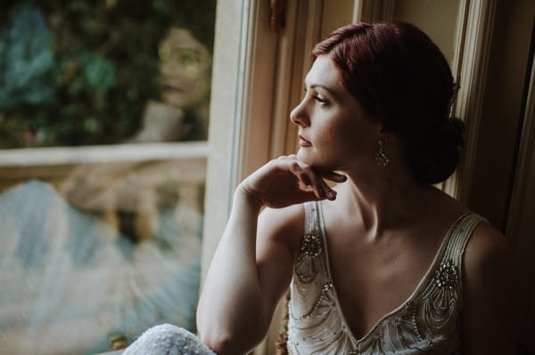 Bride looking out of window at Kilworth House