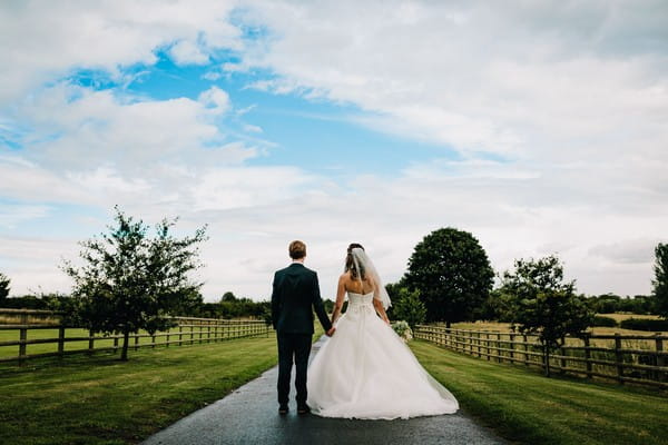 Bride and groom on driveway of Mythe Barn