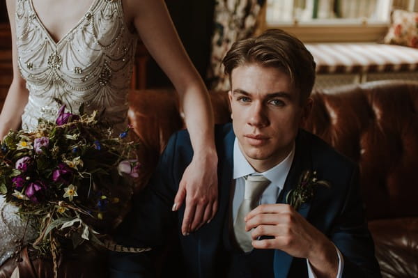 Groom sitting on couch