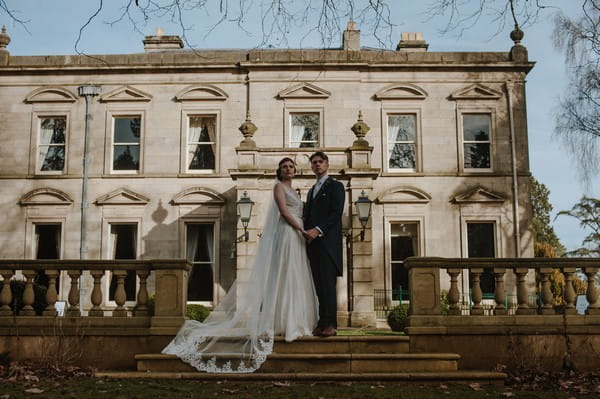 Bride and groom on steps of Kilworth House