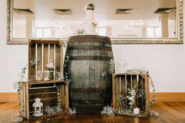 Wedding cake on barrel in middle of crates