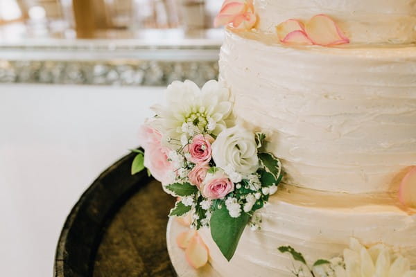 Pink and white flowers on wedding cake