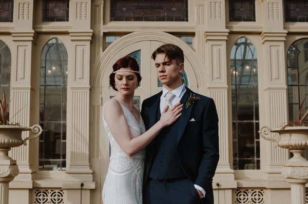 Bride with hand on groom's chest