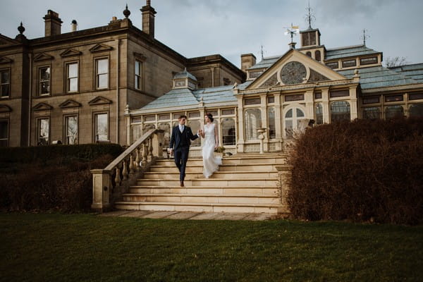 Bride and groom walking down steps outside Kilworth House