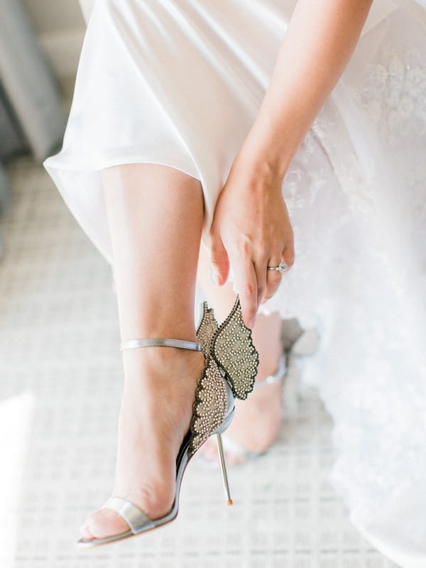 Bride putting on bridal shoes