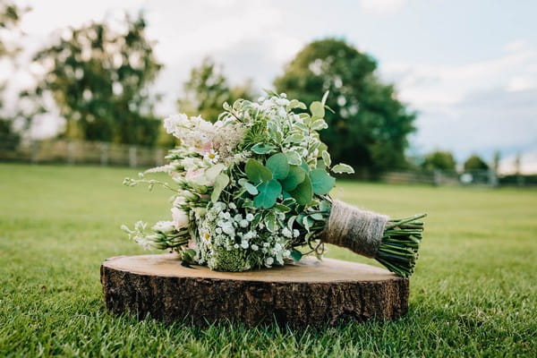 Bridal bouquet on log slice