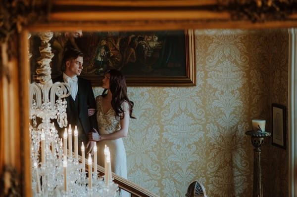 Reflection of bride and groom on stairs in mirror