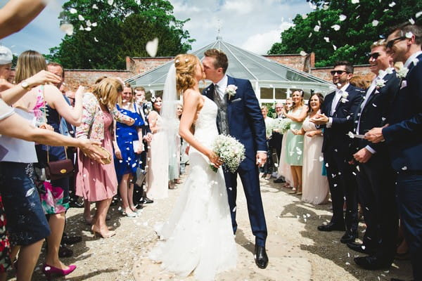 Bride and groom kissing after marrying at Combermere Abbey