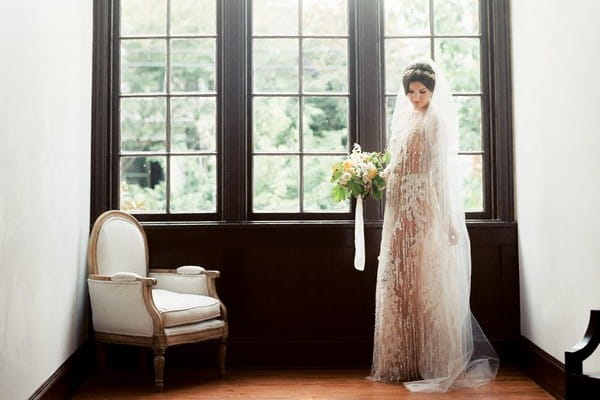 Bride standing by window