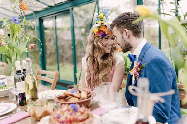 Boho bride and groom looking at each other