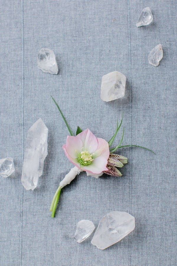 Hellebore buttonhole surrounded by quartz crystal