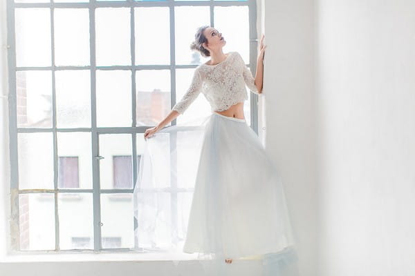 Bride standing in window