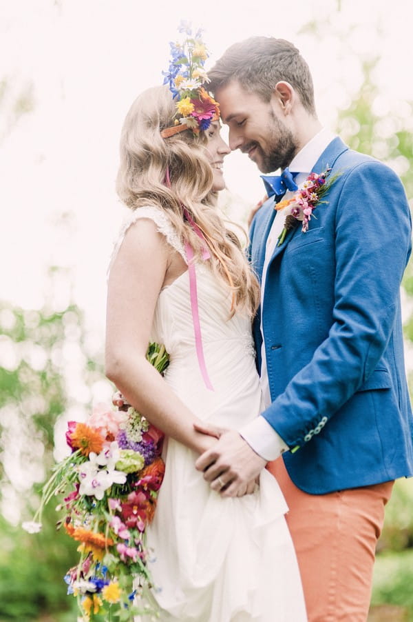 Bride and groom facing each other touching heads