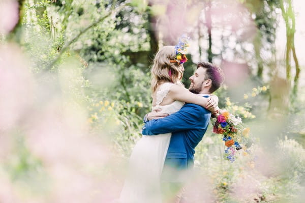 Groom lifting up bride