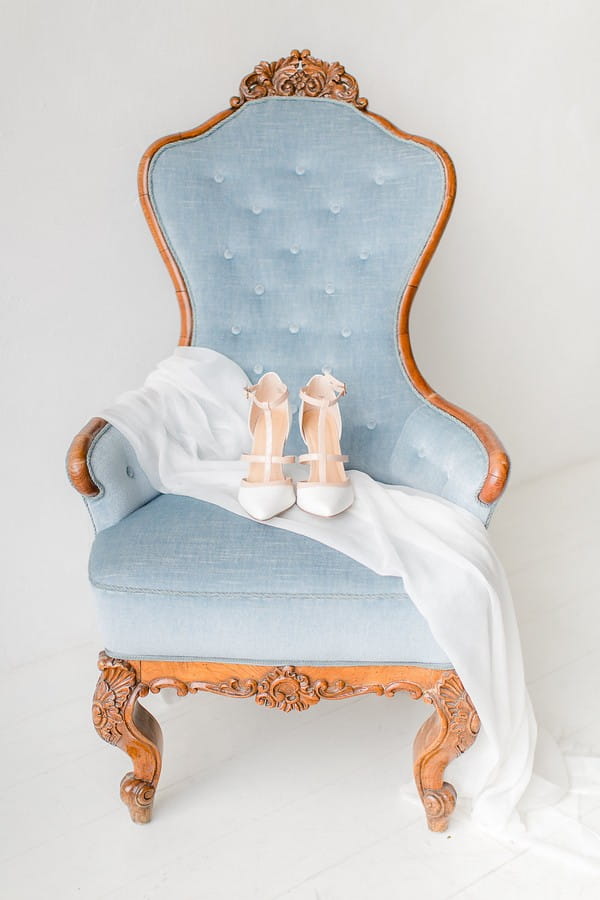 Wedding shoes and veil on chair