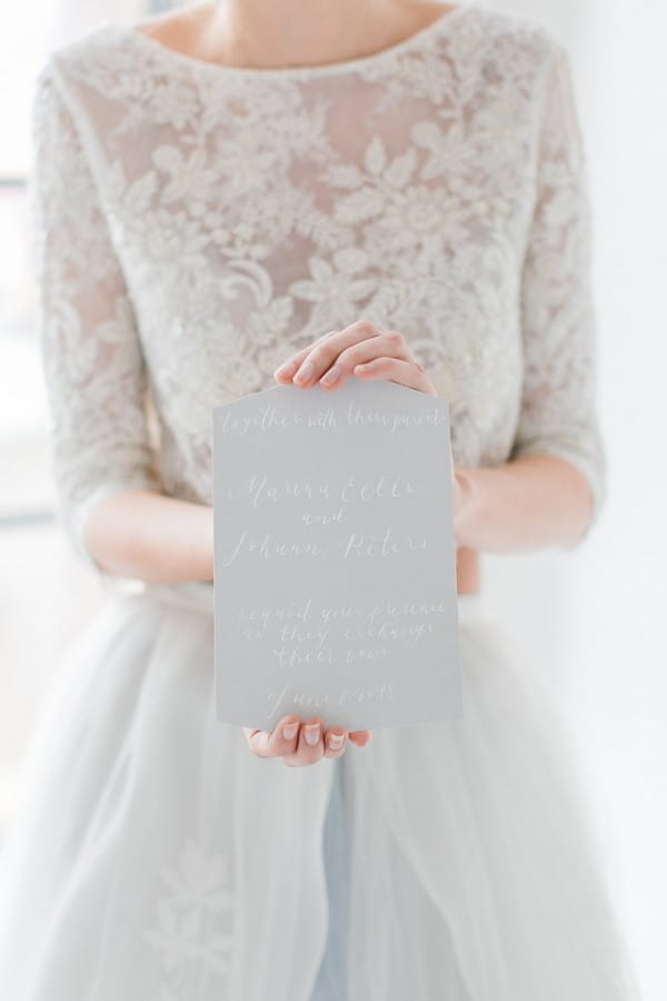 Bride holding wedding invitation
