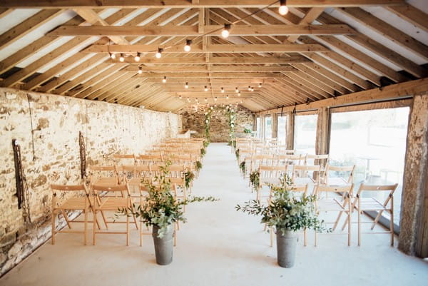 Rustic wedding ceremony set up at The Cowyard Barn at Pengenna Manor