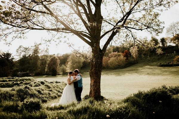 Bride and groom kissing under tree - Picture by Ryan Goold Photography