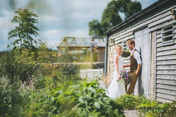 Bride and groom by shed - Picture by Lewis Fackrell Photography