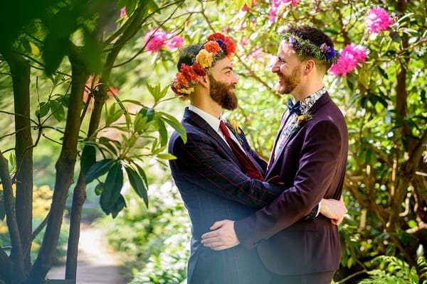 Two grooms with flower crowns facing each other - Picture by Winston Sanders Photography