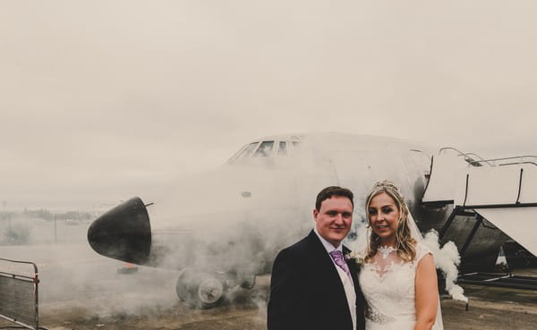 Bride and groom in front of plane - Picture by Jade Maguire Photography