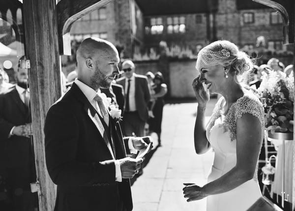 Bride wiping away tear after hearing groom's vows during wedding ceremony - Picture by Rob Dodsworth Photography