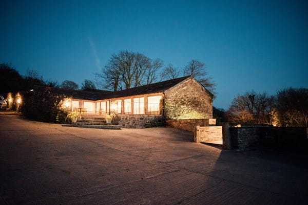 The Cowyard Barn at Pengenna Manor lit up at night