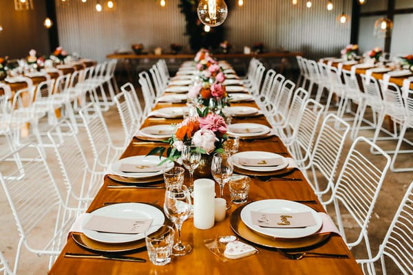 Long wedding table with flower centrepieces