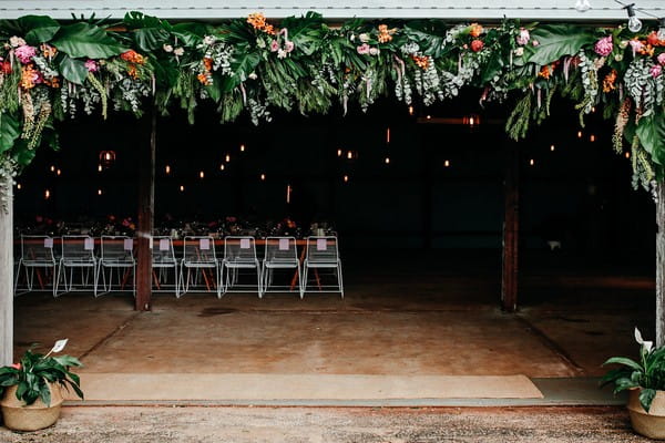 Wedding barn at Graciosa with foliage and flowers hanging from front