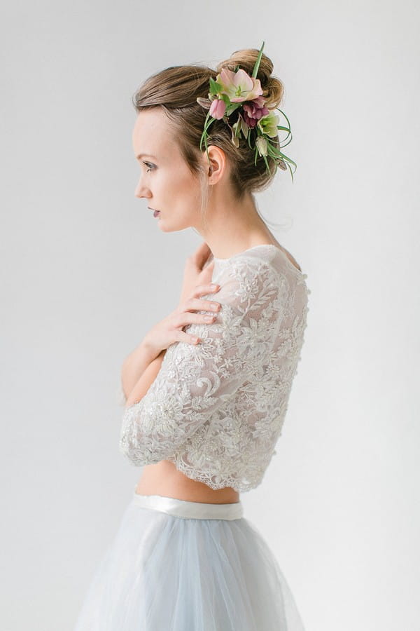 Bride wearing crop top and floral hairpiece