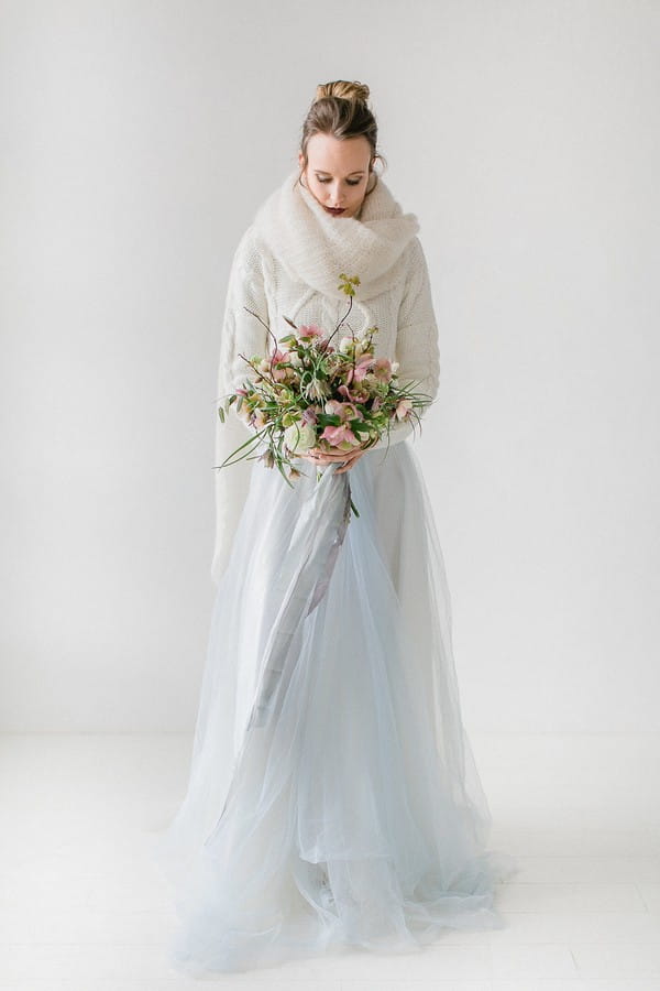 Bride with scarf holding bouquet