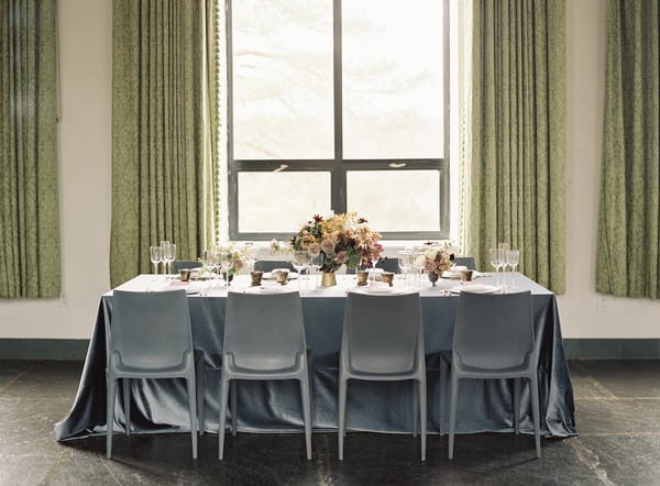 Wedding table with grey tablecloth and chairs