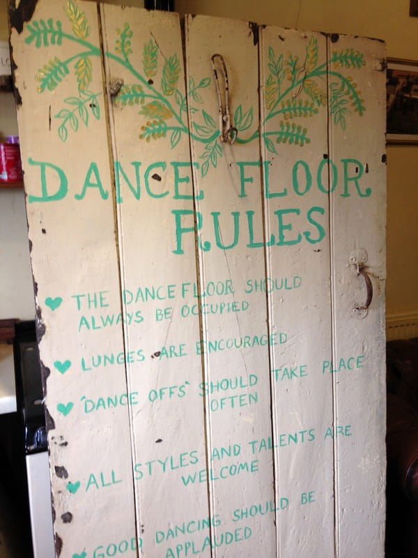 Old door with dance floor rules painted on