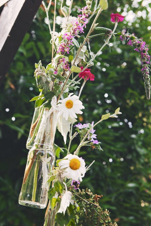 Floral Display Hanging from Beam at Outdoor Wedding