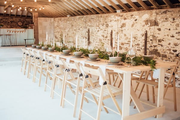 Table with rustic wedding styling in The Cowyard Barn at Pengenna Manor