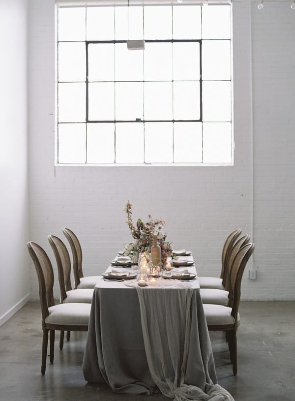 Small wedding table with grey tablecloth and tulle runner