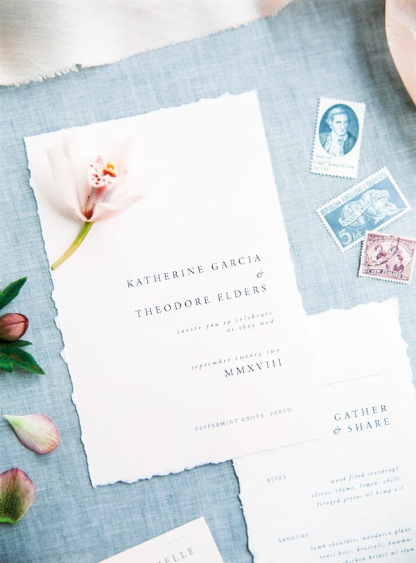 Flower on simple, elegant wedding invitation