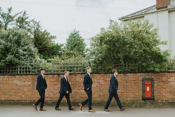 Groomsmen walking to wedding