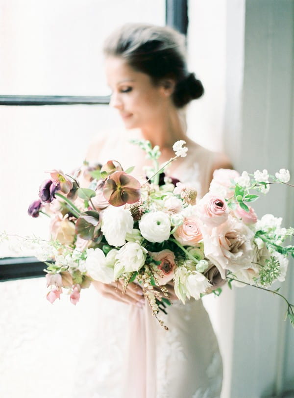 Bride holding bouquet of blush and white flowers