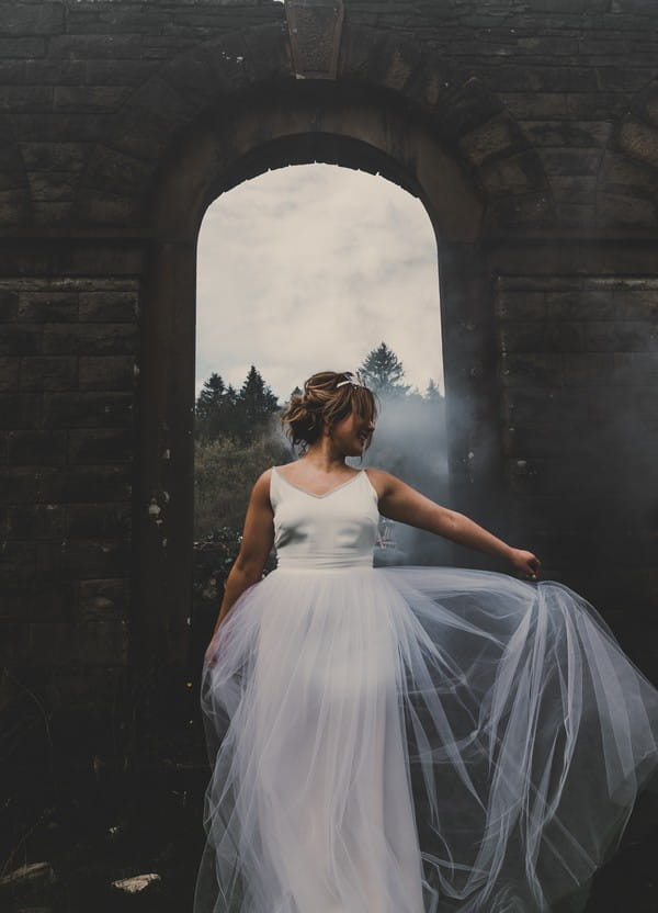 Bride holding out tulle skirt