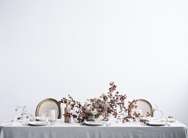 Elegant wedding tablescape with mauve and blush flowers