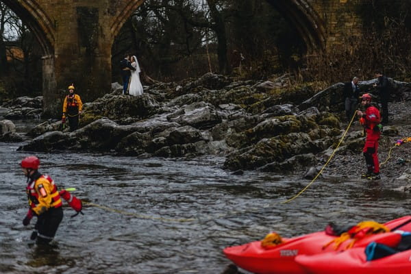 Bride and groom on rocks by people canyoning - Picture by Pixies in the Cellar