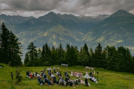 Outdoor wedding ceremony with mountains in background - Picture by Rares Ion