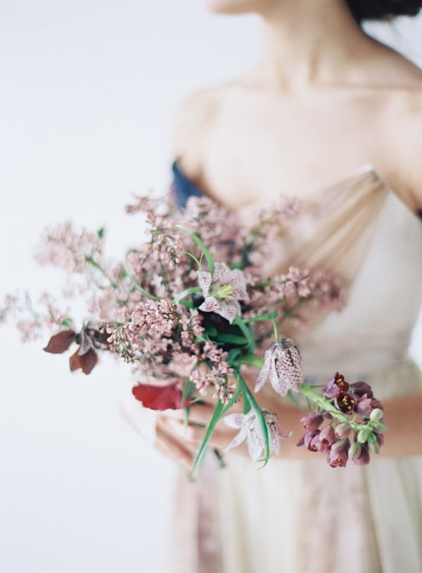 Bride holding bridal bouquet with blush flowers